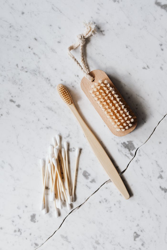 about-02 Top view layout of wooden cleaning brush and cotton swab placed on marble surface near wooden toothbrush on line chop